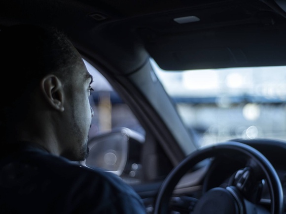 Driver behind the wheel looking at the road ahead.